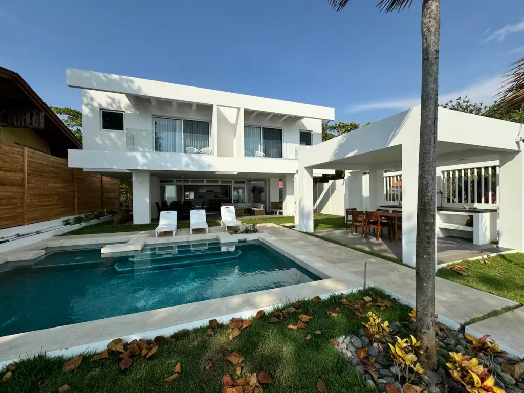 Modern white beach house with a pool, a short walk from the sand in Tivives